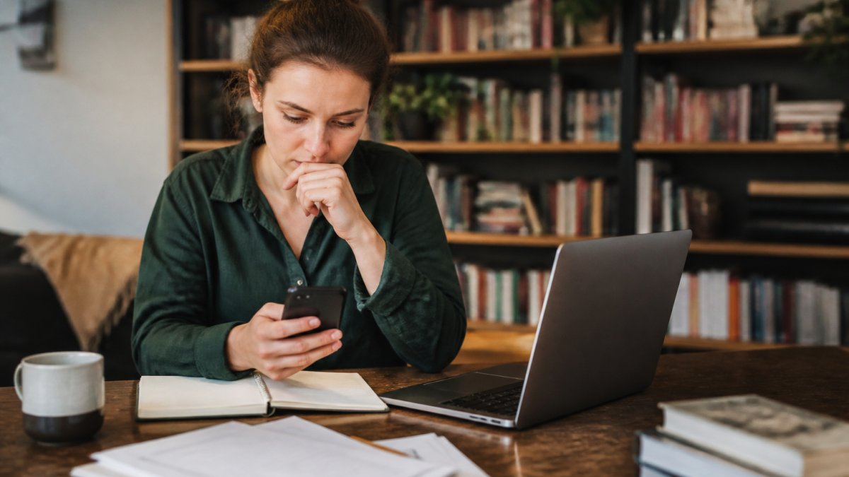 A debut author reviewing their manuscript and emails, seeking a BookSirens alternative debut for their launch.