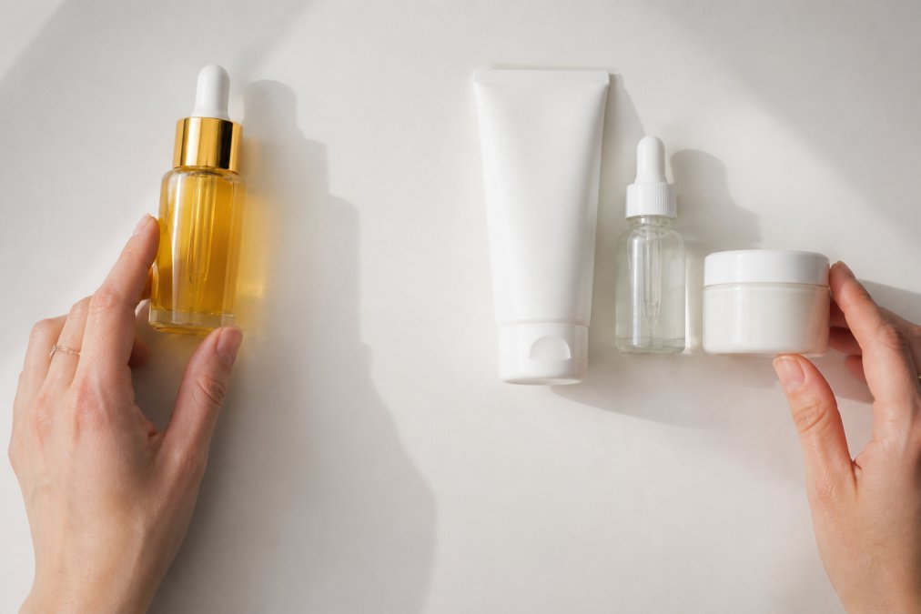 Luxury serum compared to an affordable skincare routine to evaluate skincare worth on a white surface.