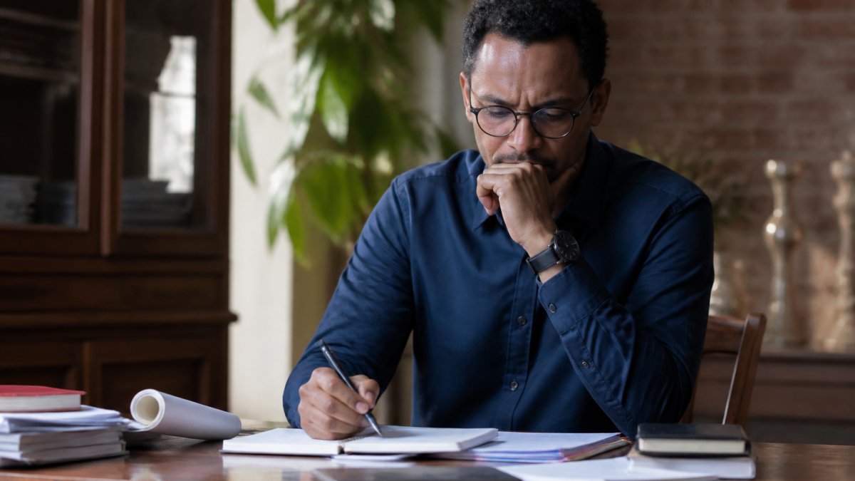 Journalist reviewing notes at a desk to ensure media coverage independent of political pressure.