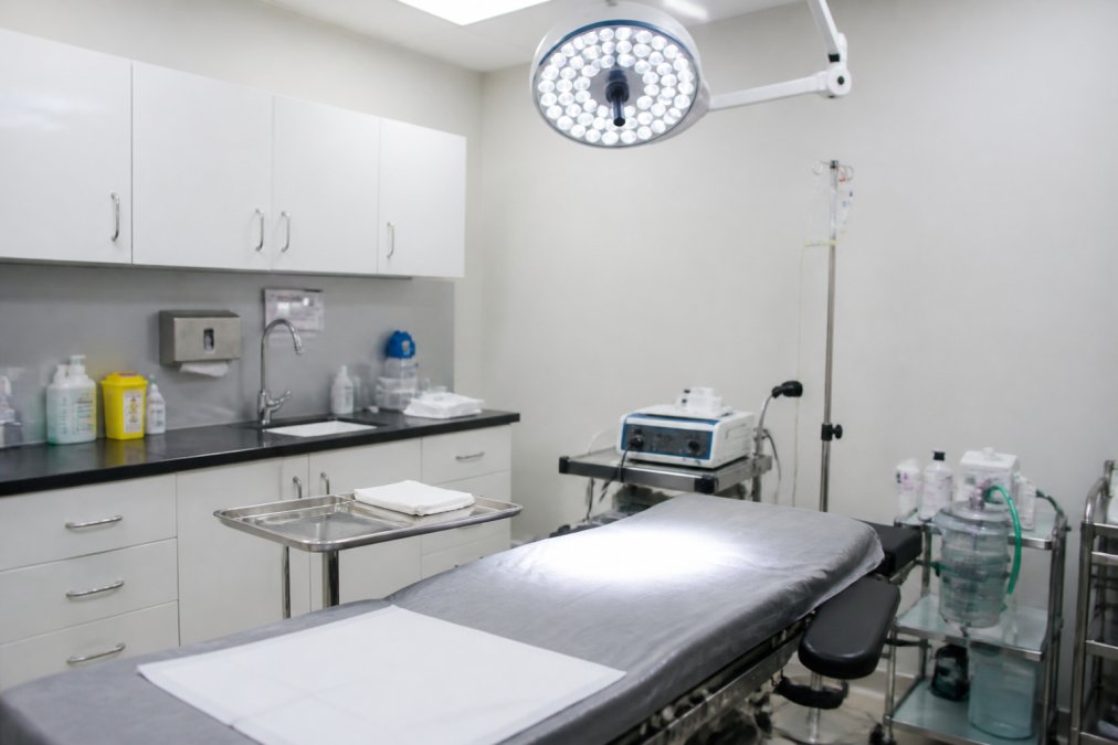 Modern sterile surgical environment with medical equipment and instruments in a clinical treatment room with bright overhead lighting