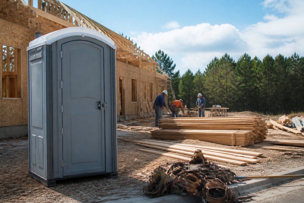 Portable toilet on a residential job site where renting a porta potty is worth it for small jobs efficiency
