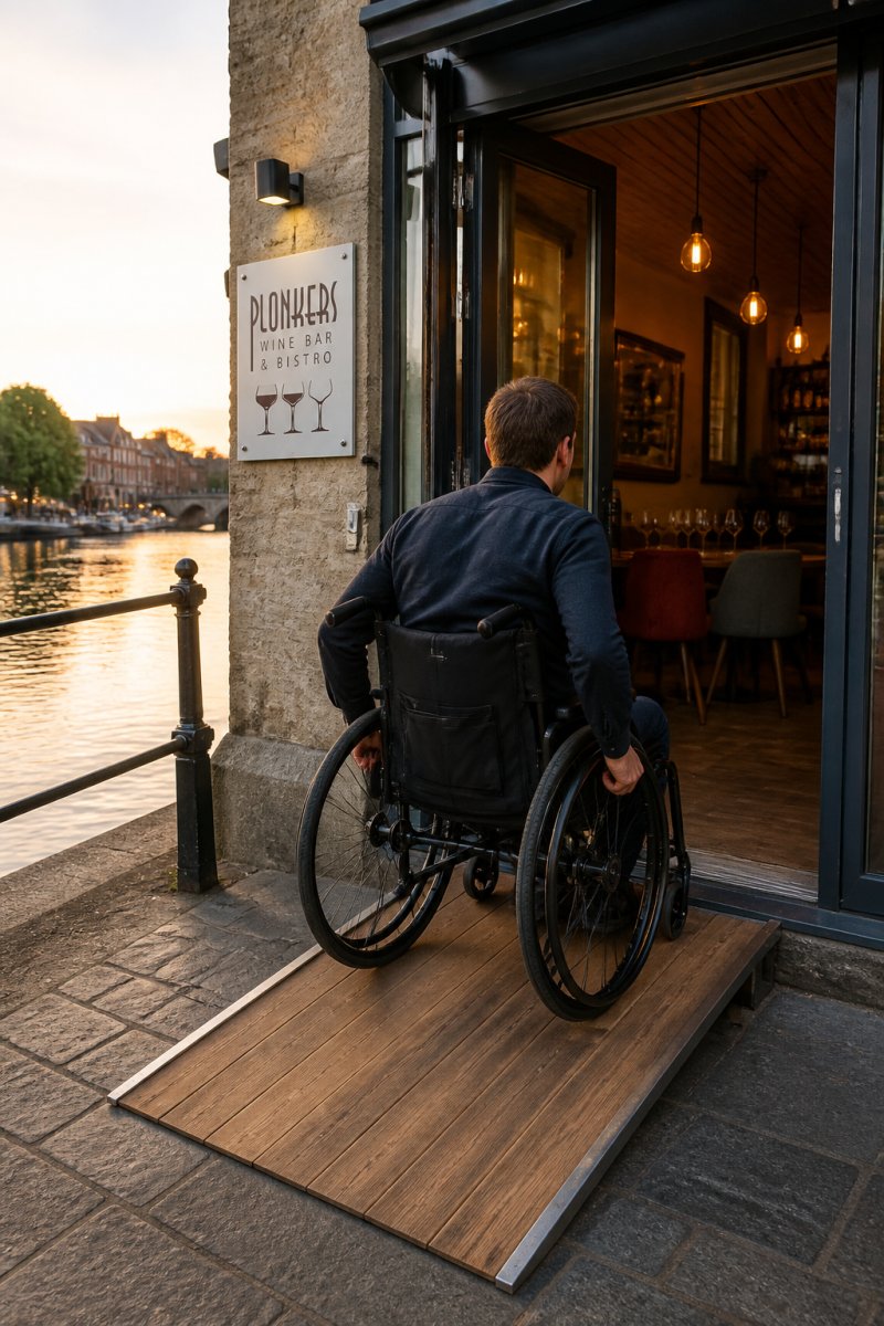 Wheelchair user entering a riverside restaurant via a level ramp, showing how accessible riverside dining in York is.