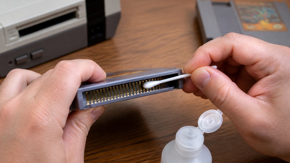 Step-by-step guide showing how to clean console pins on a retro game cartridge using isopropyl alcohol