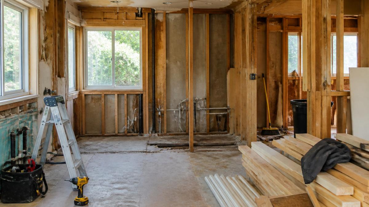 Infographic showing the demolition phase of a kitchen renovation timeline with exposed walls and framing.