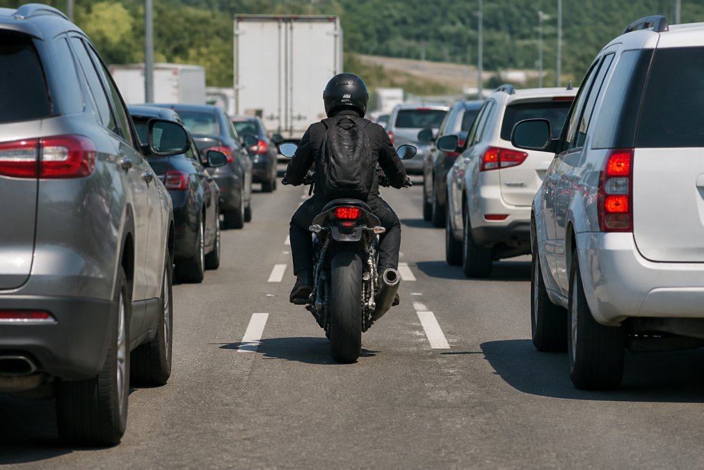 Motorcyclist riding between lanes on a Tennessee highway where lane splitting laws are under review
