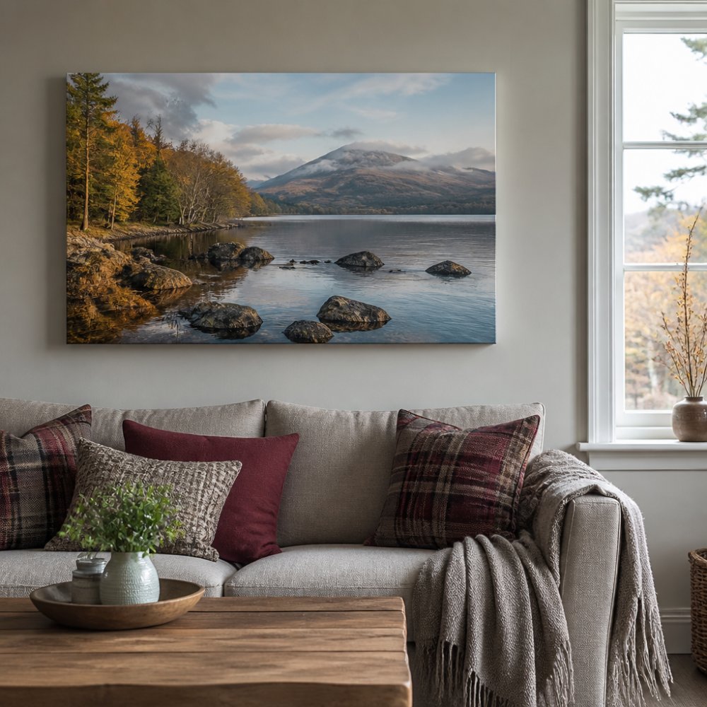A framed Loch Lomond canvas hangs above a cozy sofa with tartan cushions and a wool throw in a bright living room.