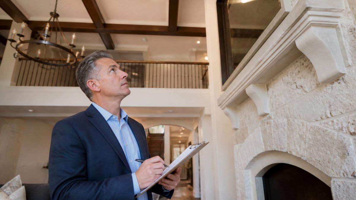 Professional appraiser examining custom architectural details to navigate luxury home appraisal challenges.