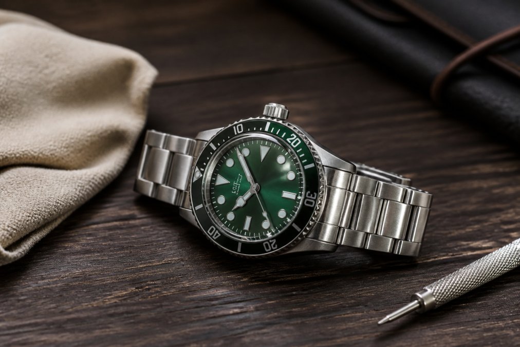 Close-up of a stainless steel Seiko Prospex watch with a green dial resting on a dark wooden surface, with a soft cloth and watch tool nearby