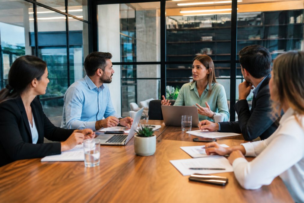 Business team analyzing marketing data on a screen while discussing magnetude consulting alternatives in a meeting.