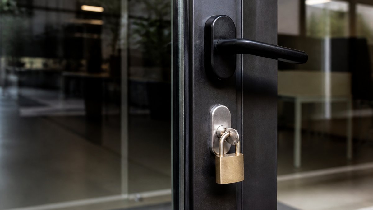 IT security team monitoring multiple screens displaying threat alerts, network activity dashboards, and real-time security metrics in a modern operations center with ambient lighting