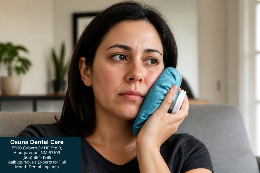 Person holding ice pack wrapped in cloth against cheek area following proper cold therapy technique for dental implant recovery, showing correct placement and comfort positioning
