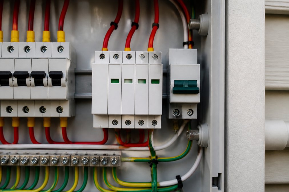 Close-up of surge protection devices installed on residential electrical switchboard showing properly mounted surge arrestors, circuit breakers, and protection equipment in a modern installation