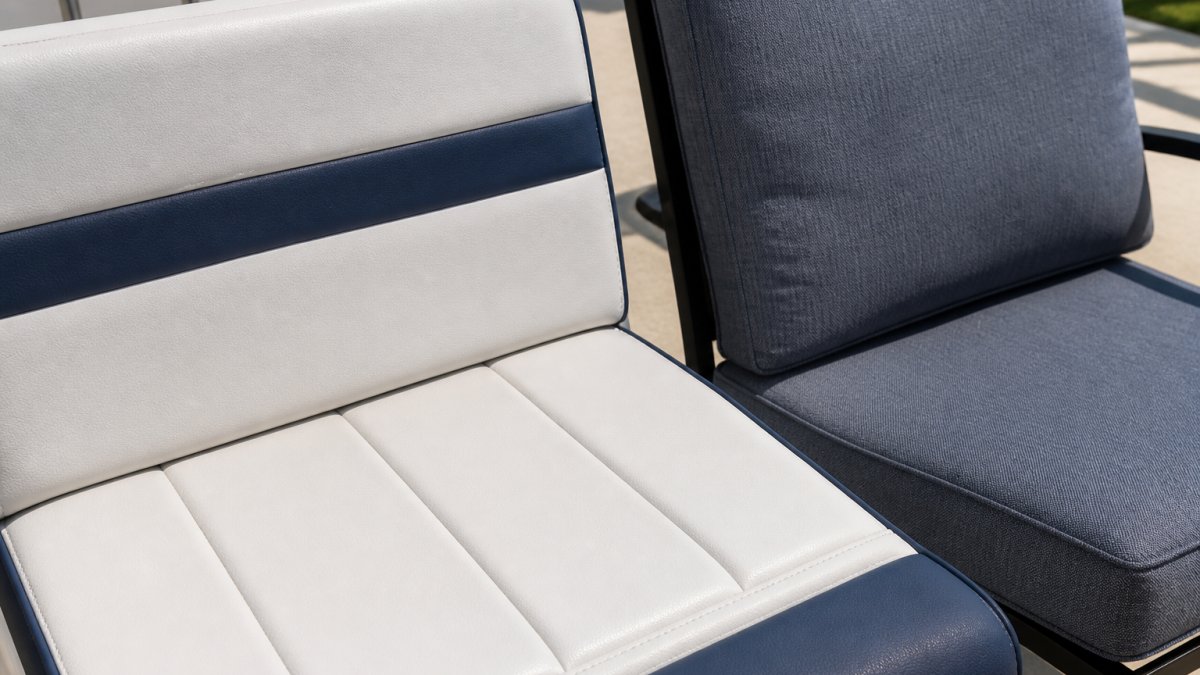 Close-up of a boat seat upholstered in marine-grade fabric next to a patio chair cushion in outdoor fabric, both outdoors in bright sunlight, showing texture differences