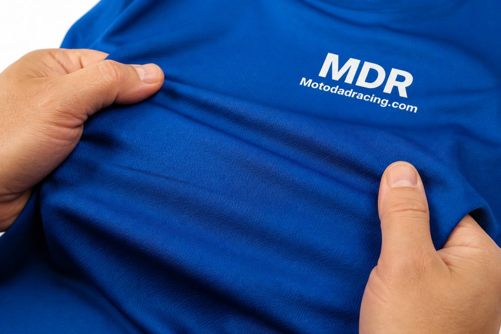 Close-up of high-quality fabric texture showing moisture-wicking material being held in hands, demonstrating durability and feel