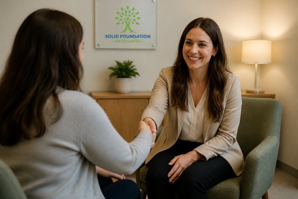 Professional therapist greeting new patient with warm handshake in calm, welcoming clinical office with soft lighting and comfortable seating