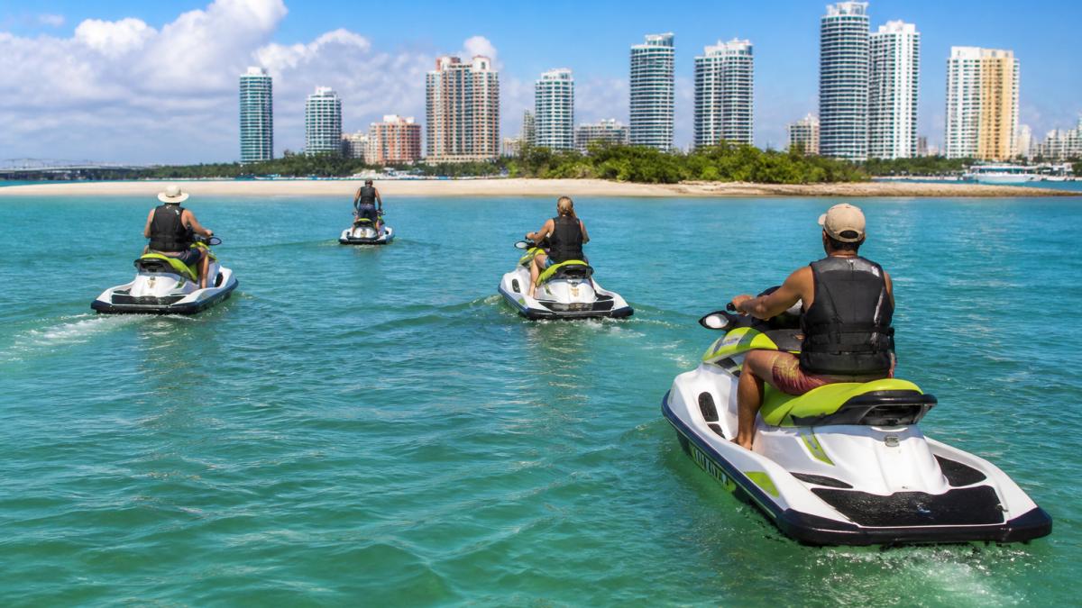 Group of riders following a guide on jet skis near a Miami sandbar, as discussed in our Miami jet ski rental price guide.