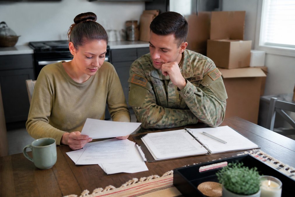 Infographic checklist for military relocation showing a couple organizing moving paperwork at a kitchen table.