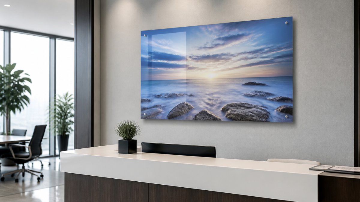 Modern office reception area with a frameless acrylic wall art piece mounted as a focal point above a sleek desk, showing the art appearing to float on the wall with natural office lighting