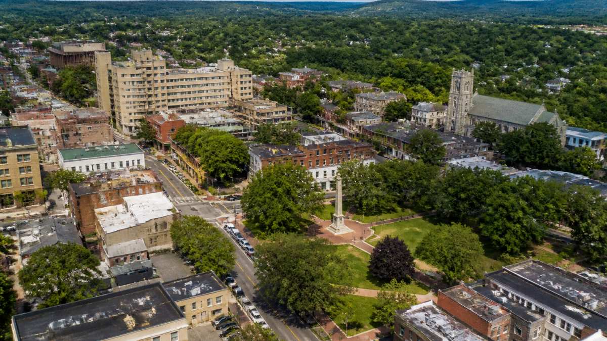 Aerial view of Morristown's historic downtown district with the Green visible, showing mixed commercial and historic architecture and tree-lined streets