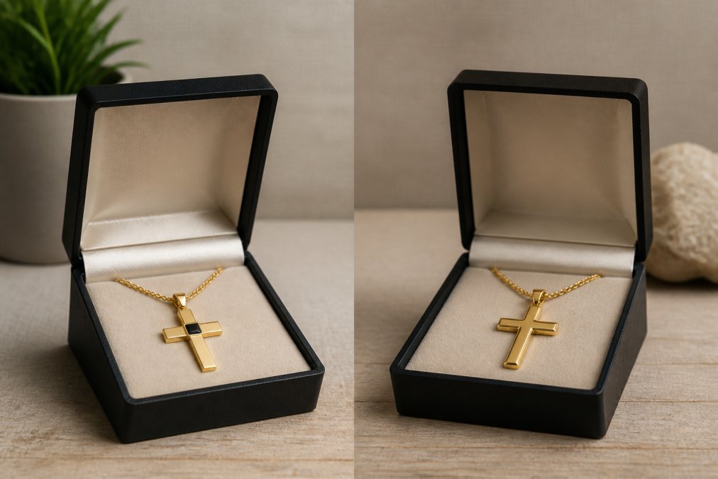 Close-up of a person's hands holding a gold cross pendant necklace with a tiny black chip centerpiece, soft natural light, neutral background