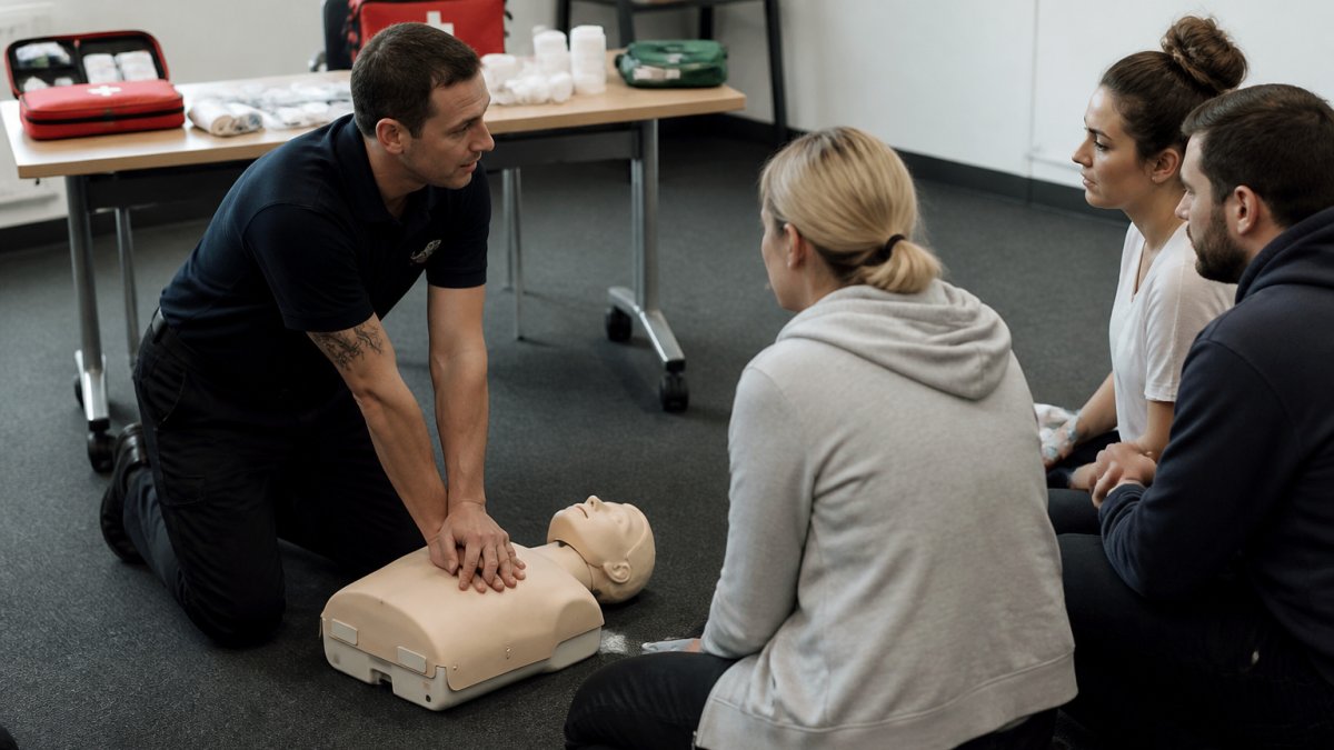 Diagram illustrating the assessment process for a first aid course with a trainer demonstrating CPR to students