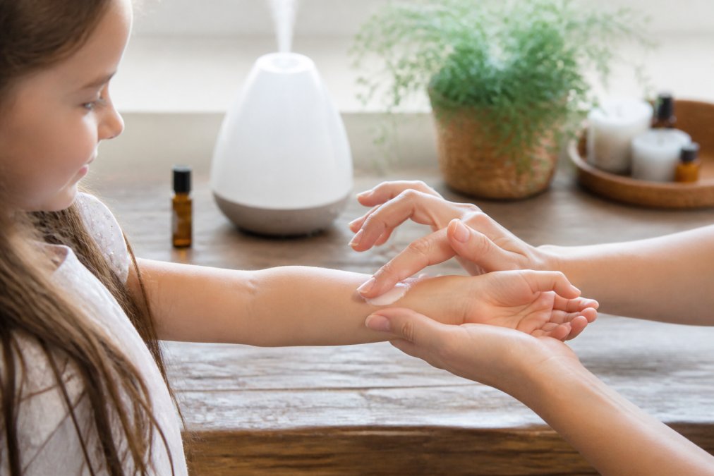 Diagram showing safe dilution ratios for natural body care when applying essential oils to a child's wrist.