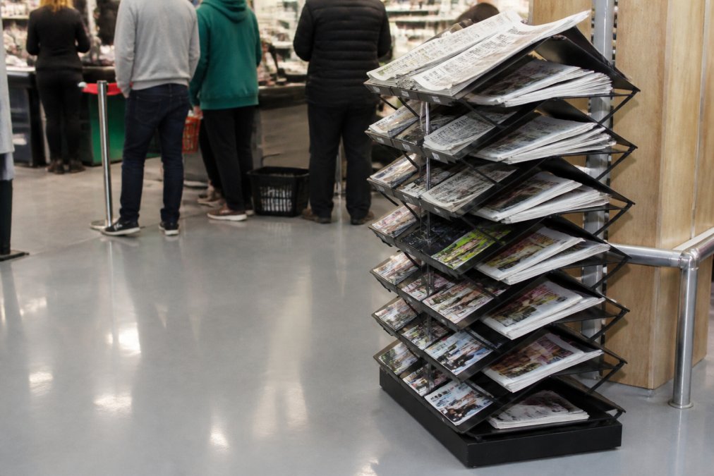 Infographic showing the 15 tier layout of newspaper stands for high-volume retail shops with organised magazine displays.
