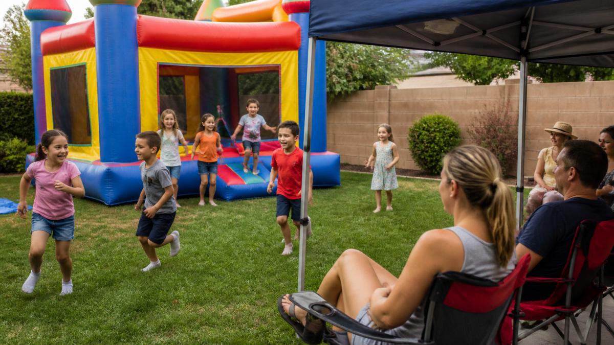Children playing near a colorful bounce house during backyard party rentals for a birthday celebration