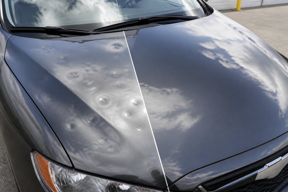Vehicle with visible hail damage and door dings on hood and panels, showing before-and-after comparison with repaired surface restored to smooth, original appearance