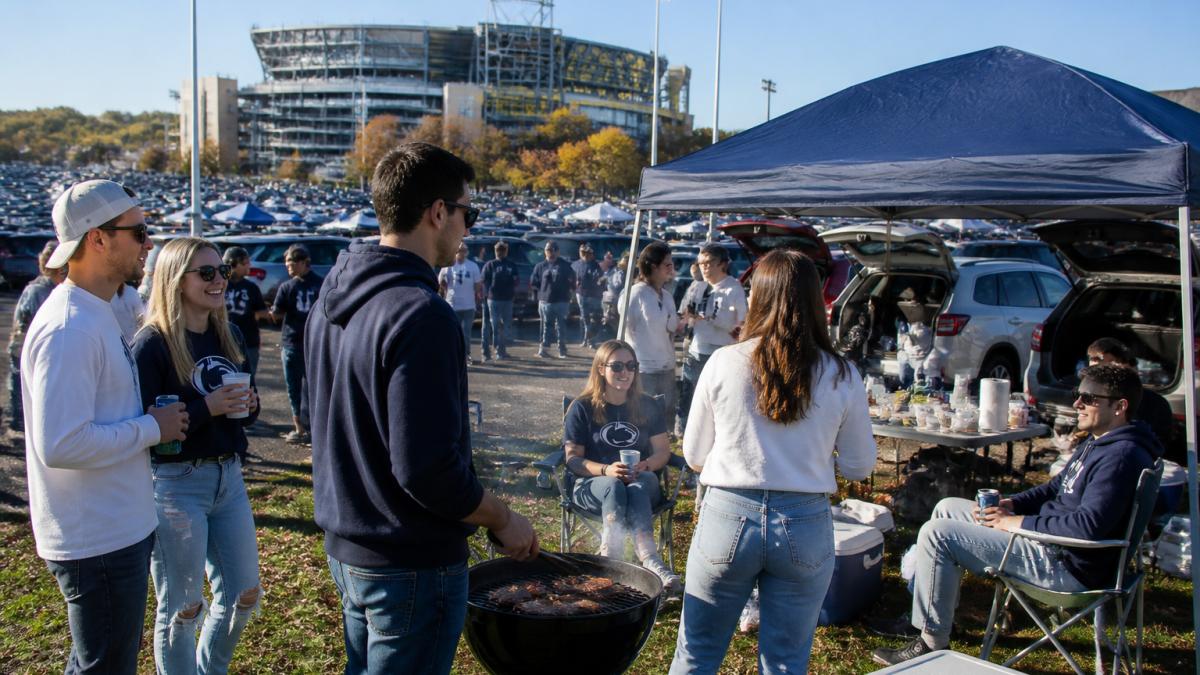 Penn State fans tailgating near Beaver Stadium for a penn state game day parking guide experience.
