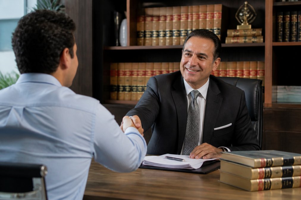 Attorney shaking hands with a client, representing the success of a personal injury attorney Glendale CA
