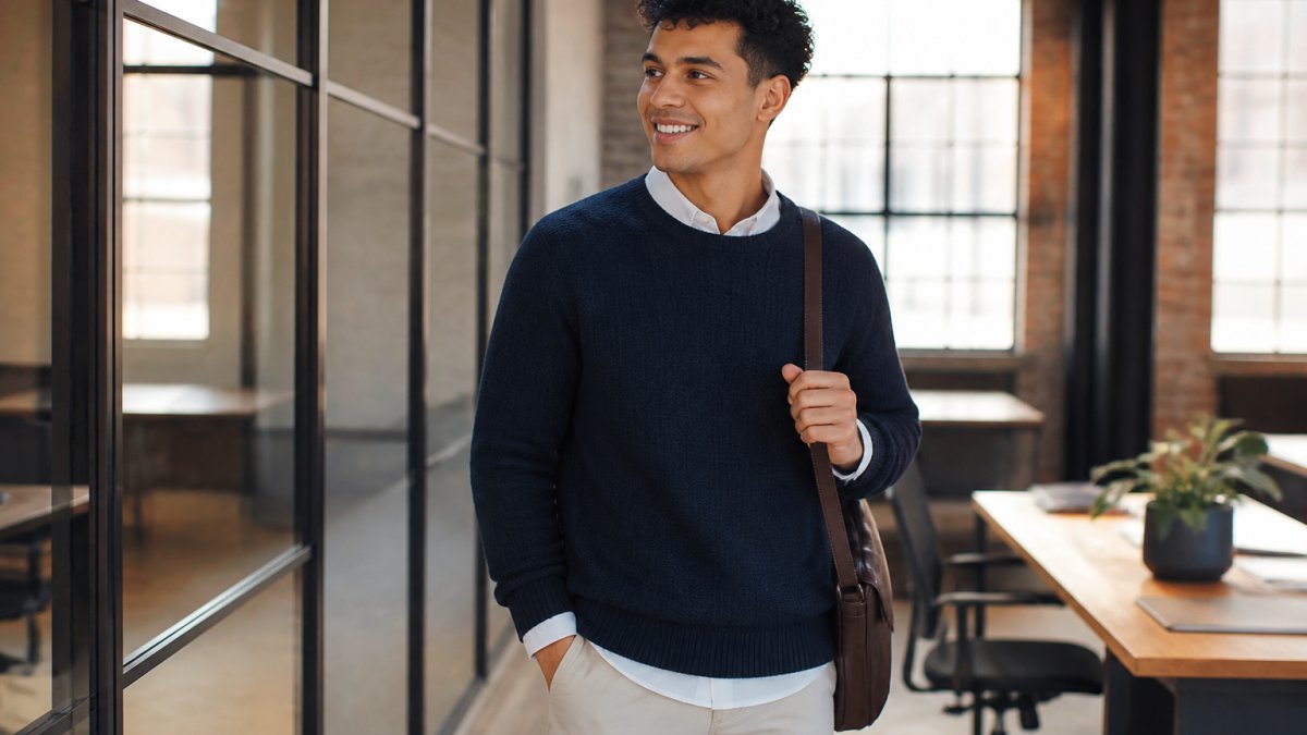 Young adult wearing a thoughtfully styled outfit that combines comfort and personality, standing in natural lighting with confident posture, showing how personal style translates to real-world wear