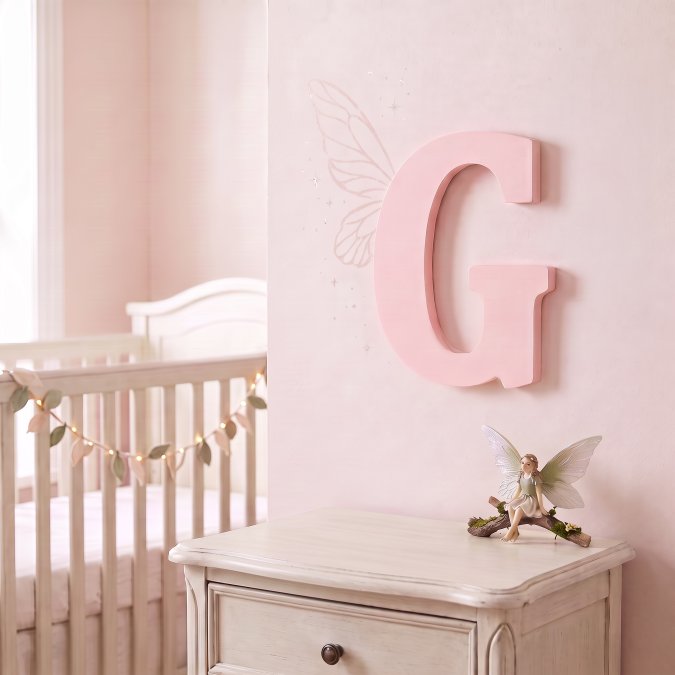 Baby pink monogram letter hands on wall in a girls bedroom