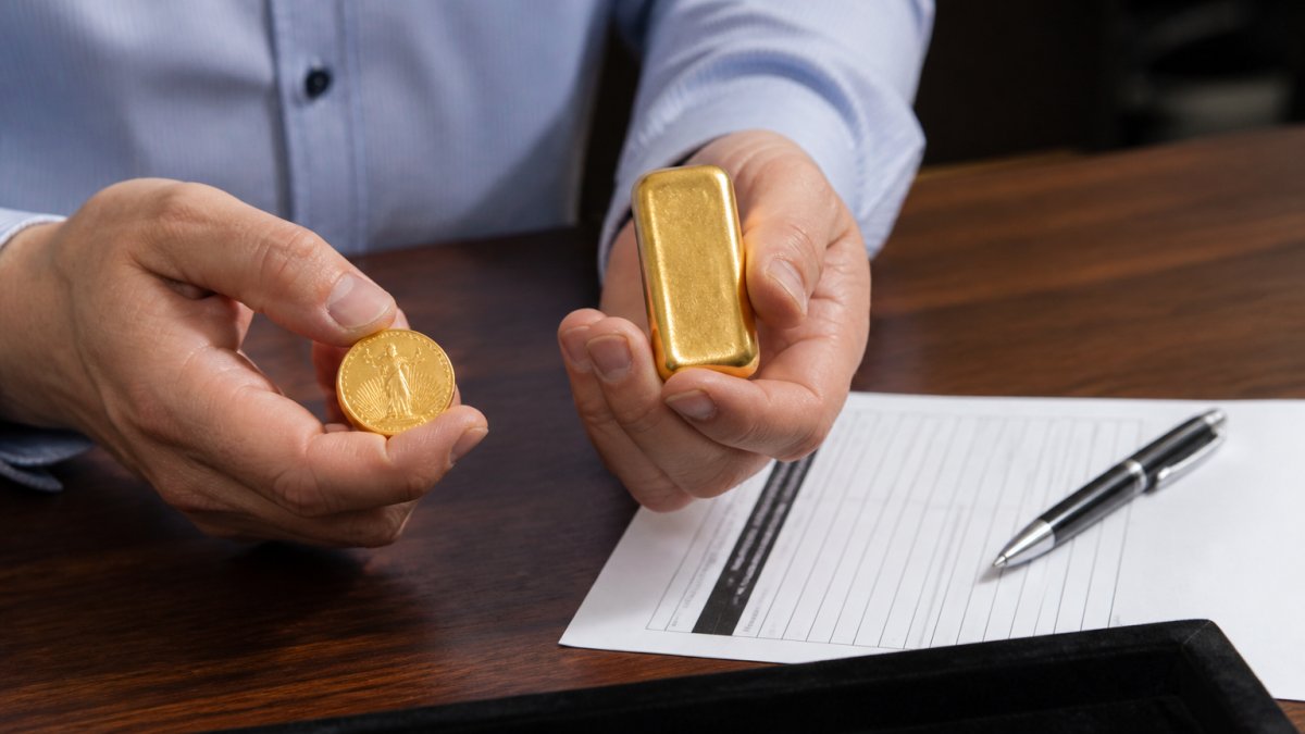 Hands holding a gold coin and bullion bar over a desk with a valuation document