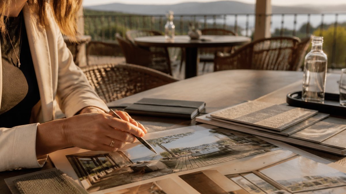 An elegant executive retreat venue with a private terrace overlooking a scenic landscape, set for a small group meeting