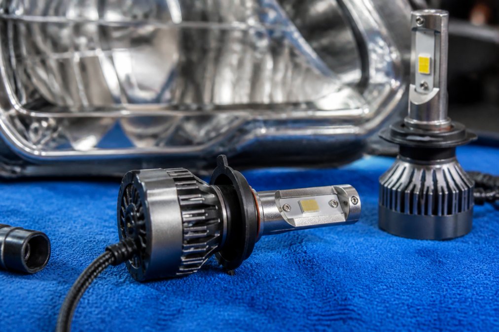 Close-up of premium LED headlight bulb with visible aluminum alloy heat sink fins and active cooling fan, demonstrating thermal management design and component architecture