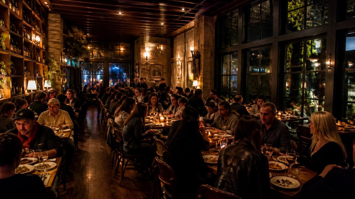 Guests enjoying handcrafted dishes in the warm, chic atmosphere of a private dining Los Angeles restaurant space.