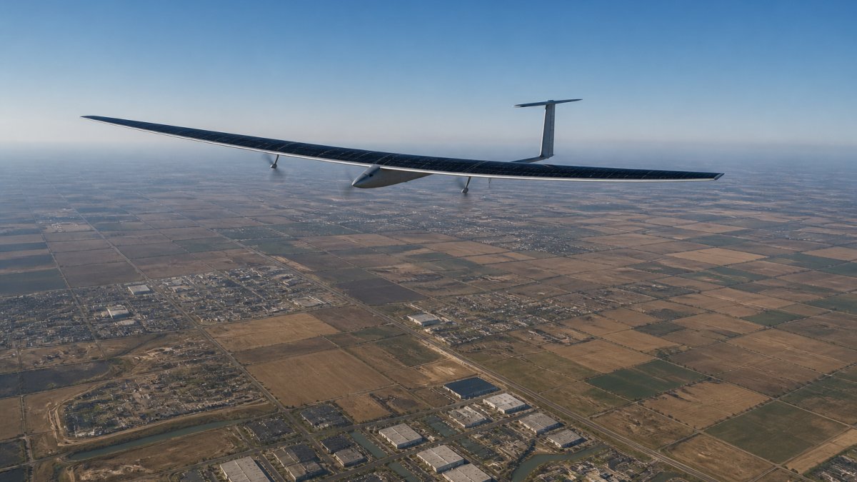 Advanced solar-powered aircraft suspended in clear stratosphere above patchwork of farmland and infrastructure, demonstrating persistent surveillance coverage of defined geographic area below