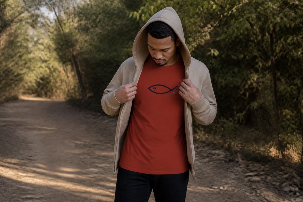 Man layering a Christian hoodie over a long-sleeve crewneck tee in lifestyle setting, demonstrating versatile styling for different seasons and occasions with natural lighting