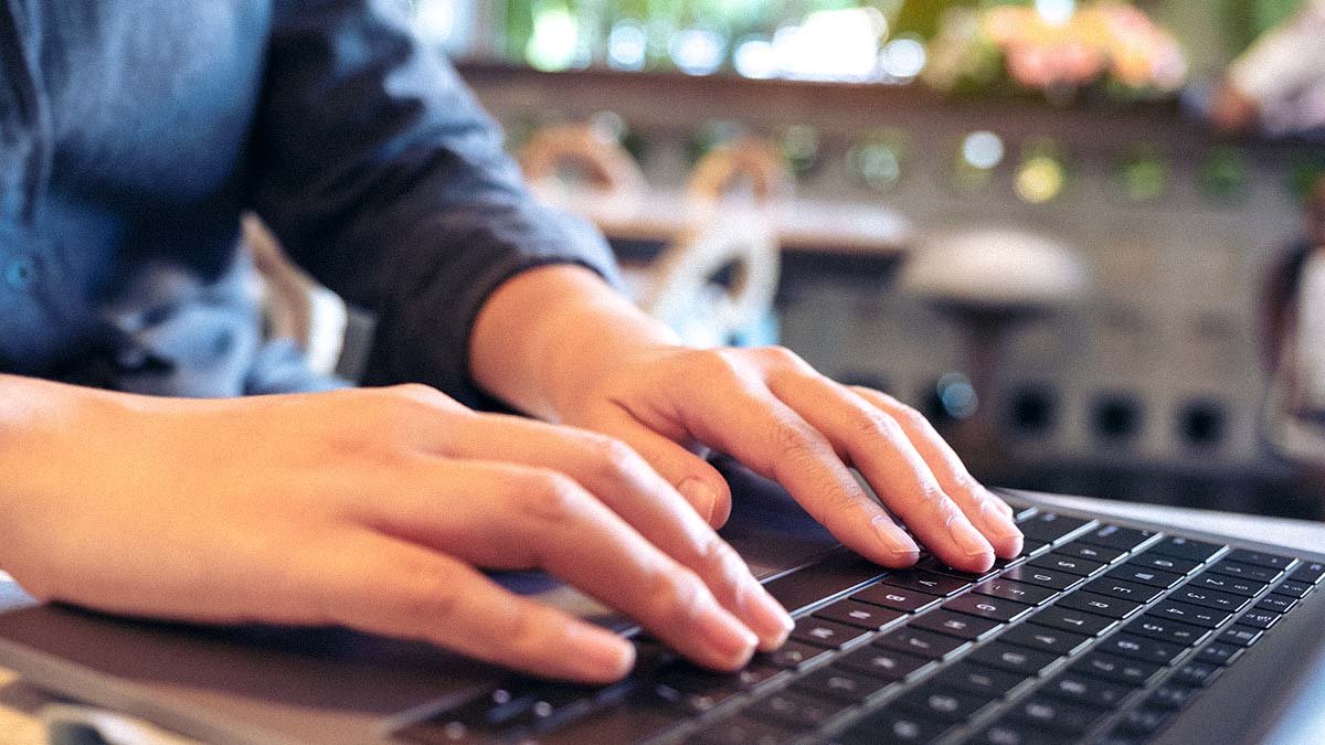 Employee typing on laptop