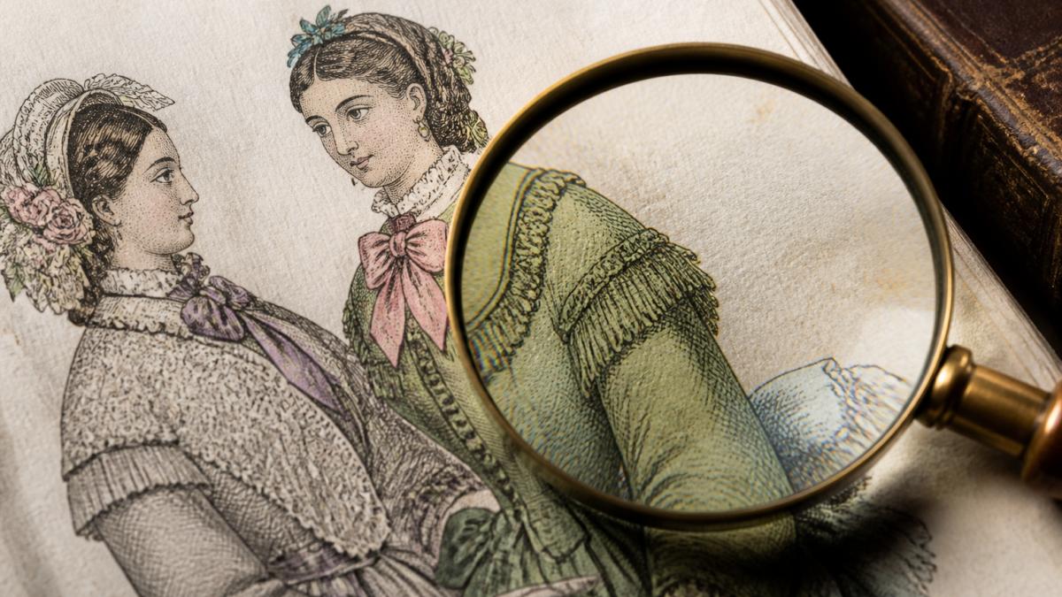 Close-up detail of hand-coloured steel engraving showing fine line work, pigment texture, and aged paper with a magnifying glass nearby for inspection