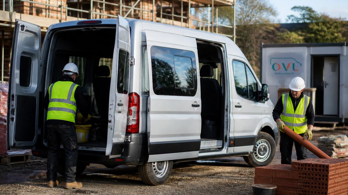 Crew van parked at a commercial construction site with workers loading equipment and materials into the vehicle, natural daylight