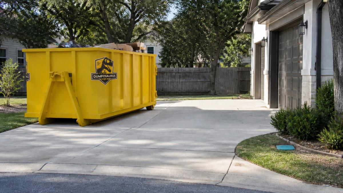 Roll-off dumpster safely positioned on a residential driveway with clear spacing from the home, showing proper access and placement for safe delivery