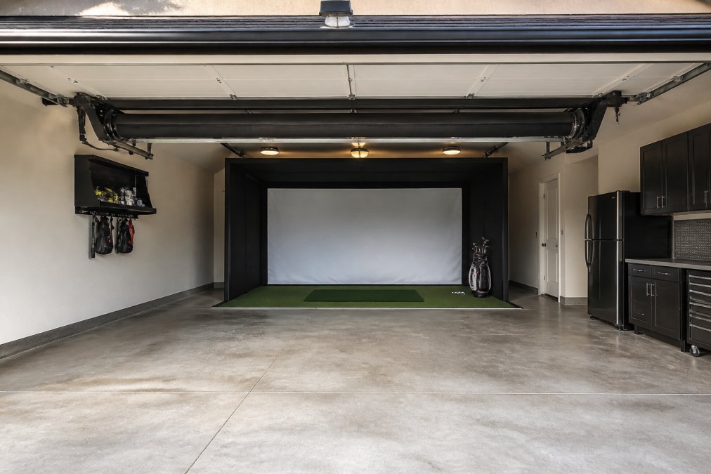 Professional illustration showing retractable golf simulator enclosure