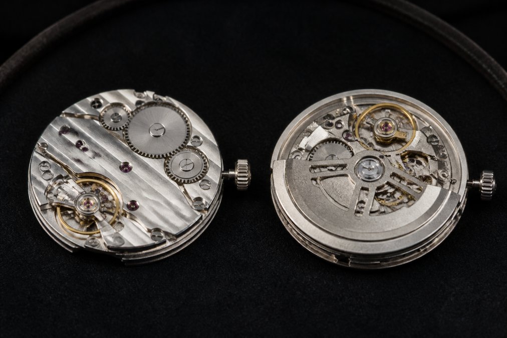 Macro photograph of an intricate watch movement with Geneva stripes and polished beveling visible, displayed on a dark velvet surface with soft directional lighting highlighting the finishing details