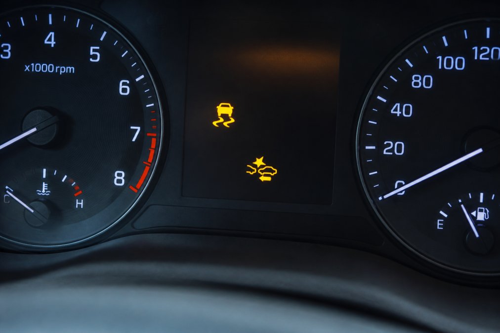 Roadside Safety Devices for Professional Drivers Close-up of vehicle dashboard showing electronic stability control and autonomous emergency braking system indicators illuminated during active operation