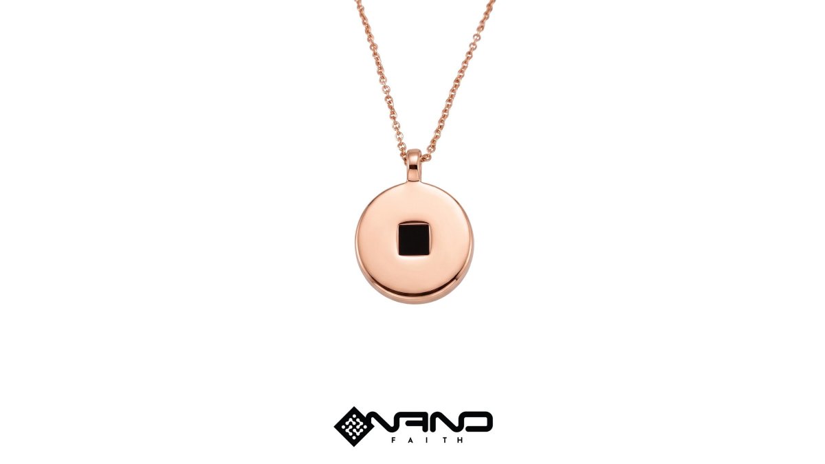 Close-up of a woman's neck and collarbone wearing a rose gold circular disc pendant necklace, soft natural window light, elegant neutral blouse