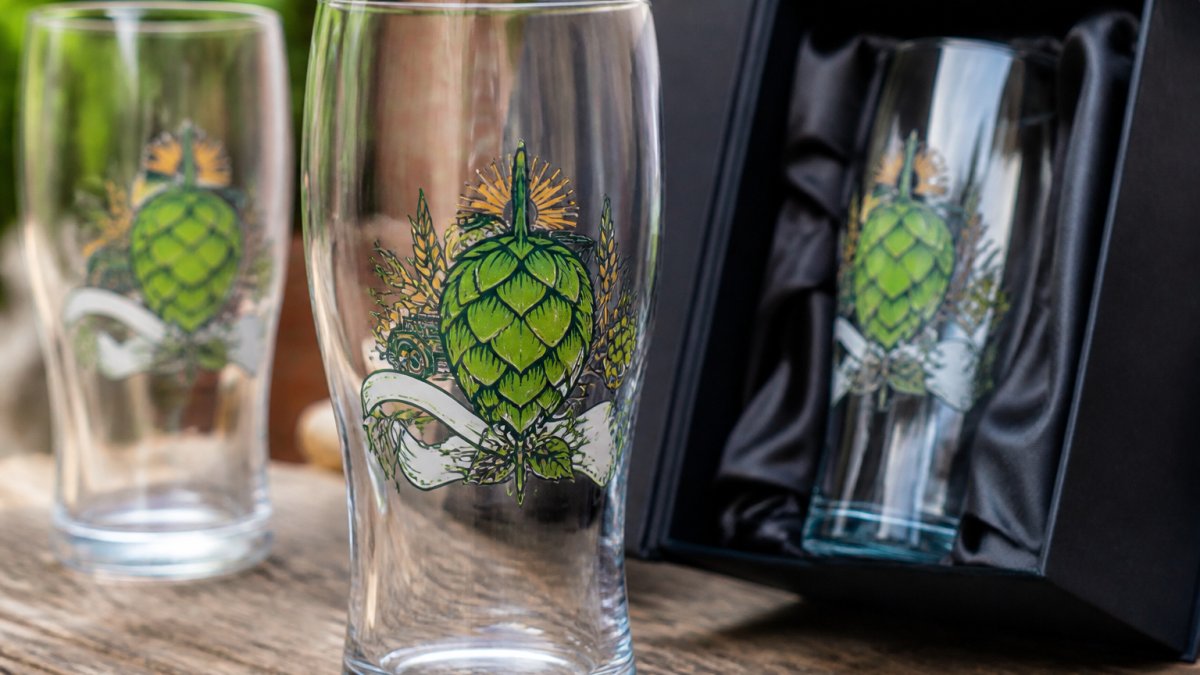 Close-up of vibrant screen-printed logo on a branded beer glass showing crisp colour and fine detail against clear glass surface in natural light