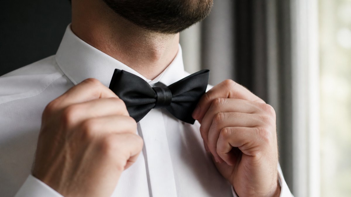 Diagram illustrating the formal process of adjusting a silk bow tie for a wedding ensemble