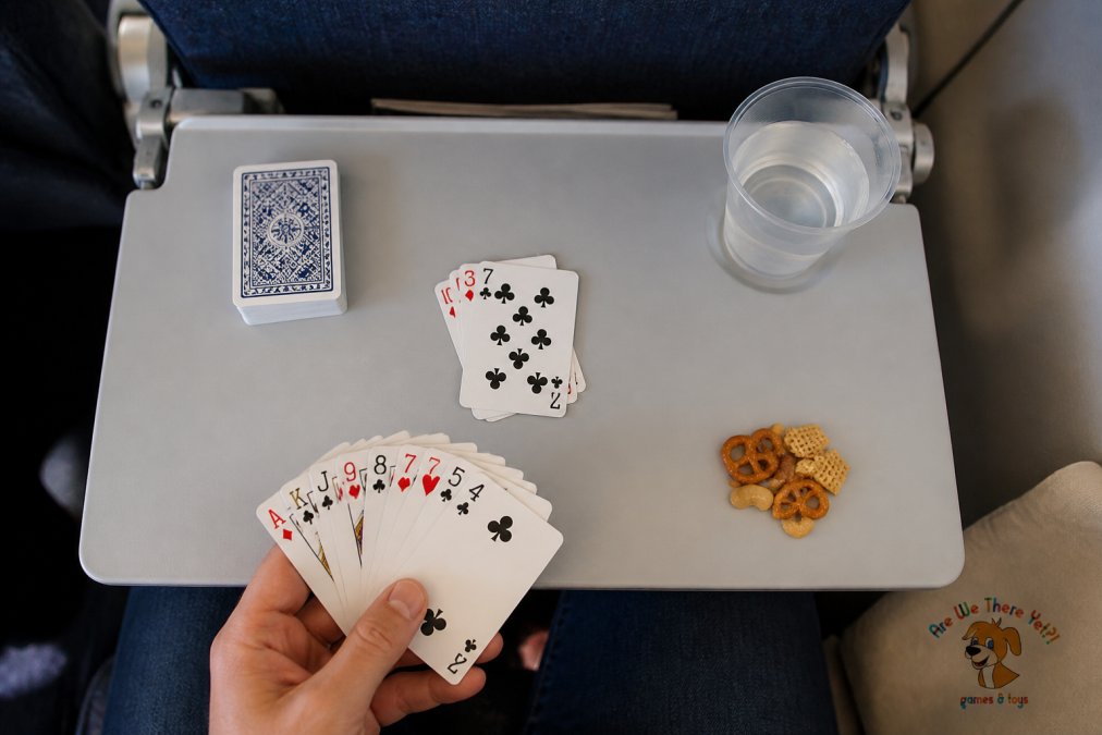 Diagram showing a tray table setup for simple card games for long flights with space for drinks and snacks